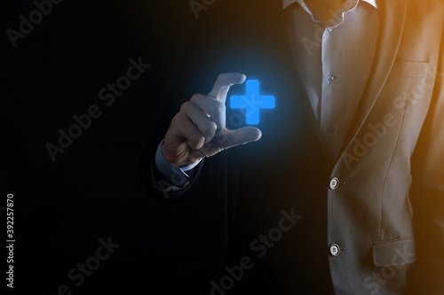 Businessman, man hold in hand offer positive thing such as profit, benefits, development, CSR represented by plus sign.The hand shows the plus sign