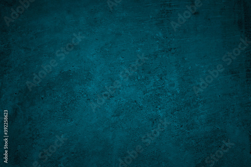 Blue green grunge background. Dark abstract rough background. Toned concrete wall texture. Combination of teal color and grunge texture. photo