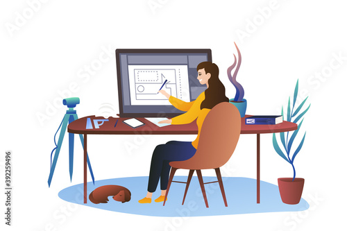 An architect girl sits at a large graphic tablet. Cozy office at home, measuring device. The dachshund sleeping under the table.