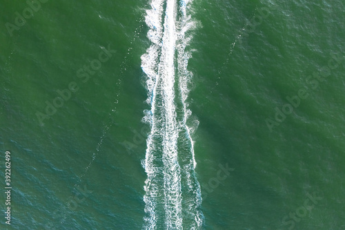 Trail on the water surface behind the motor boat. © Amerigo_images