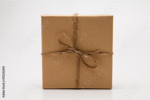 Brown parcel Kraft gift box present on white background