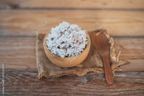Cooked organic rice in a bowl on wooden table