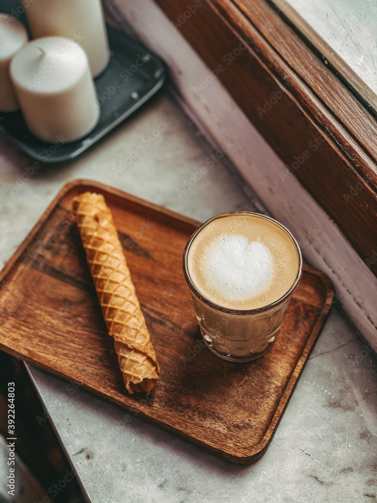 Coffee on the window sill with a waffle Coffee on the window sill with a waffle