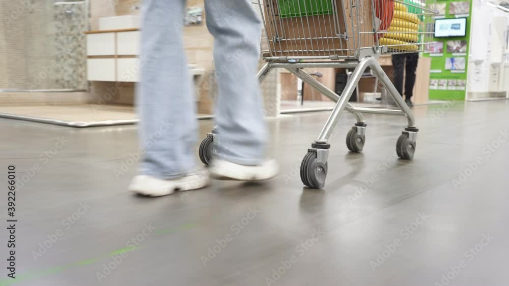 Close-up of woman in market aisle, looking for things they need in their new house. Shopping in hypermarket. Close-up of woman in market aisle, looking for things they need in their new house. Shopping in hypermarket.