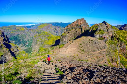 Beautiful hiking trail from Pico do Arieiro to Pico Ruivo, Madeira island. Footpath PR1 - Vereda do Areeiro. On summy summer day above the clouds. Portugal.