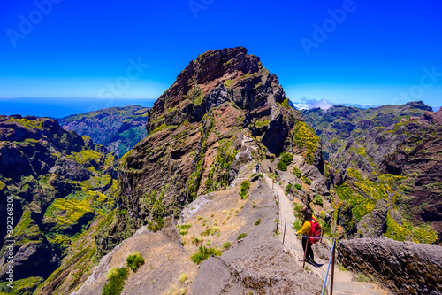 Beautiful hiking trail from Pico do Arieiro to Pico Ruivo, Madeira island. Footpath PR1 - Vereda do Areeiro. On summy summer day above the clouds. Portugal. photo