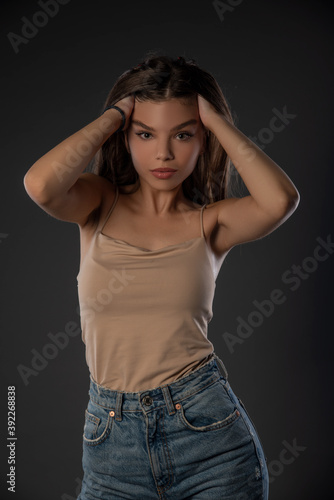 Portrait of beautiful girl posing in studio on grey background. Isolated  © Bogdan