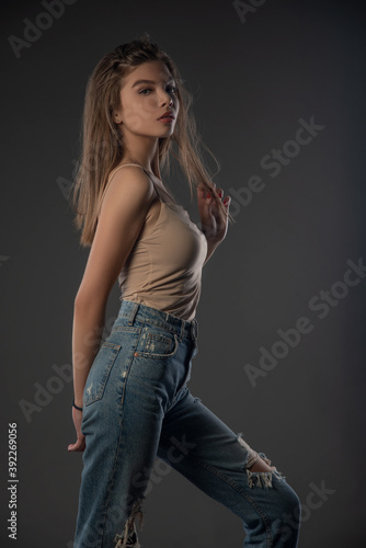Portrait of beautiful girl posing in studio on grey background. Isolated 