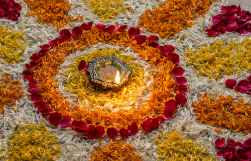  Flower petal rangoli for Diwali with diwali diya selective focus 