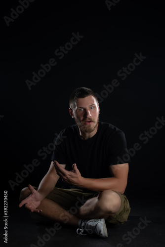 Funny guy posing on black backgroung. Isolated