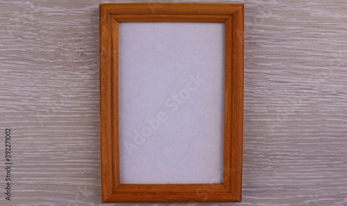 Wooden frame for photo on wooden background © Valeria F