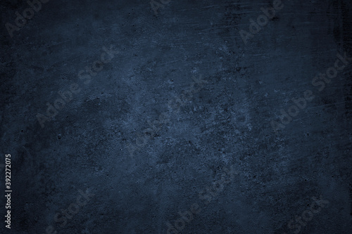 Dark grunge background. Black blue abstract rough background. Toned concrete wall texture.