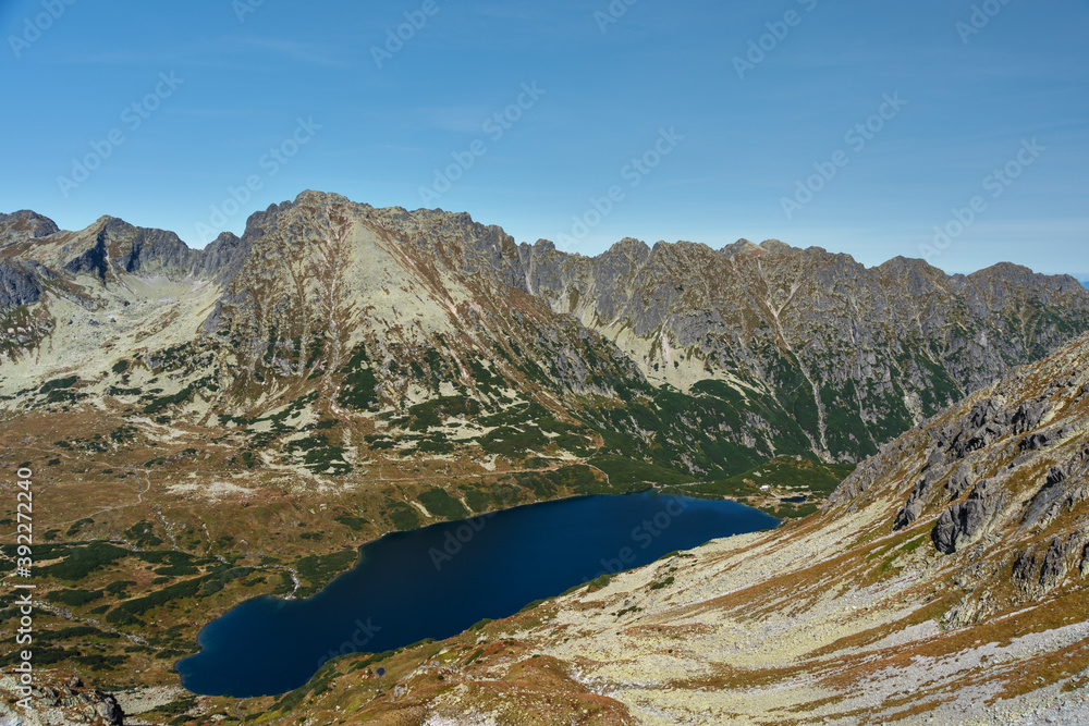 Landscapes with a tourist on a background of mountains and lakes with evening lighting