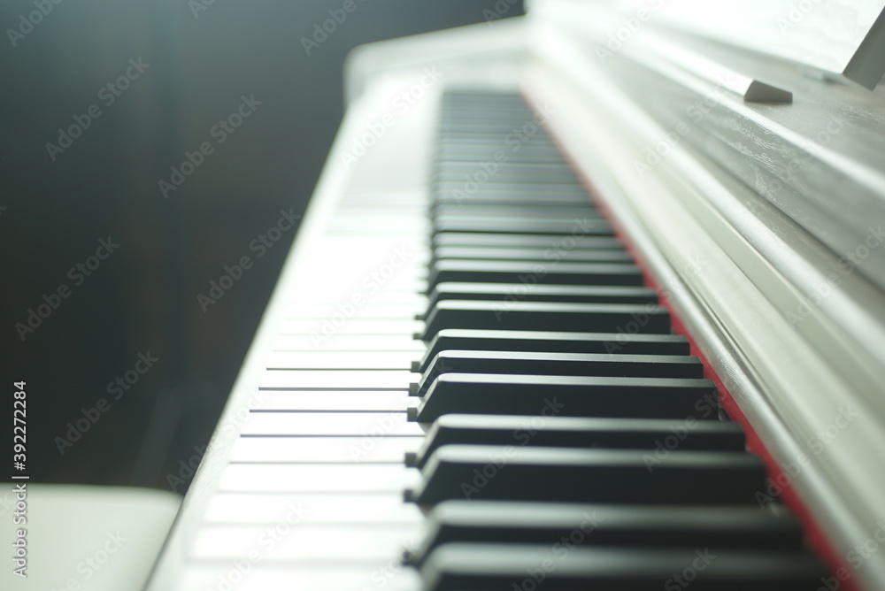 white piano on a dark background white piano on a dark background