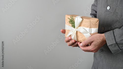 man holding a new year gift in pajamas