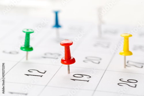 Push pins on calendar. Idea concept of to do planning.