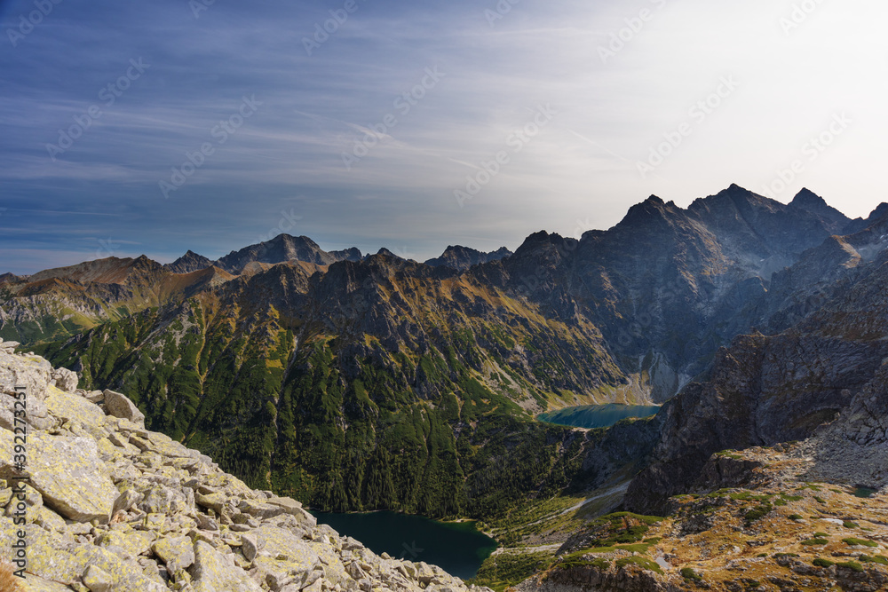 Landscapes with a tourist on a background of mountains and lakes with evening lighting