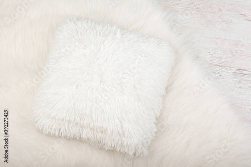 White shaggy carpet and cozy pillow background. Home interior background