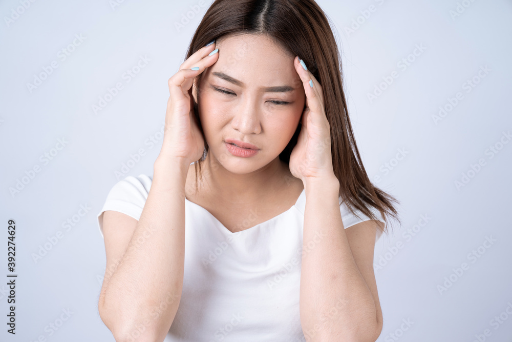 Asian woman suffering from headache, Isolated on a white background. Asian woman suffering from headache, Isolated on a white background.