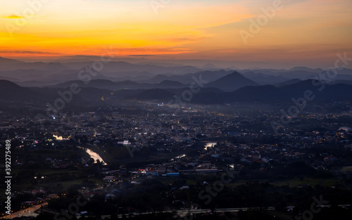 City surrounded by mountains at sunset, Phu Bo Bit view point, Loei, Thailand, Oct 26, 2020.