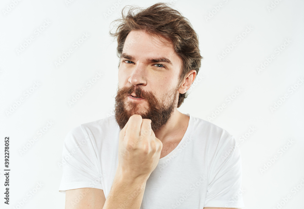 Young man in white t-shirt emotions model gesturing with hands