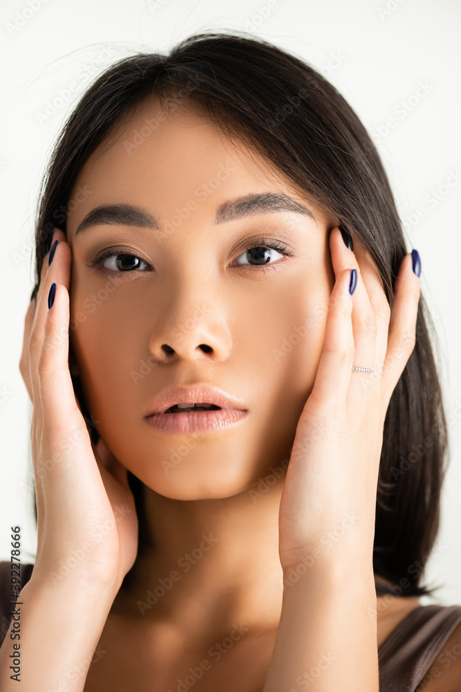 young asian woman looking at camera isolated on white young asian woman looking at camera isolated on white