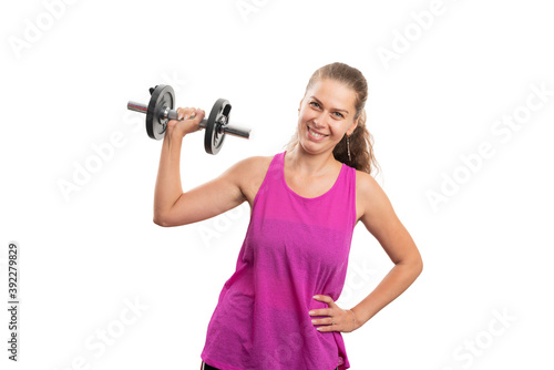 Woman lifting weights to tone biceps wearing pink sportswear