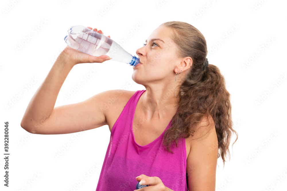 Woman wearing fitness attire drinking water after workout Woman wearing fitness attire drinking water after workout