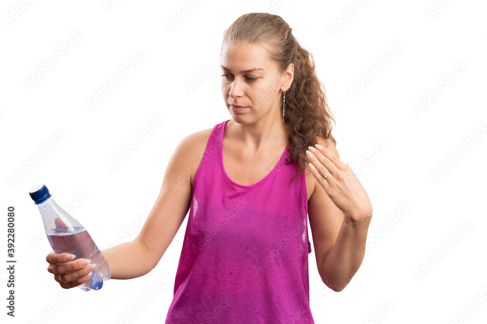 Fit woman at workout looking at water bottle as hydration concept Fit woman at workout looking at water bottle as hydration concept