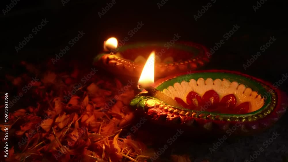 Colorful clay diya or oil lamps lit during Diwali festival. Happy Diwali.
