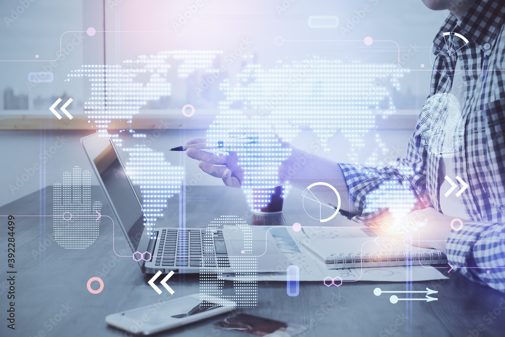 Multi exposure of world map hologram with man working on computer on background. Concept of worldwideweb.