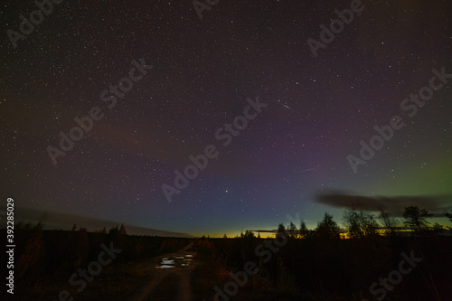 Aurora on the night starry sky. Landscape in the north of Russia.