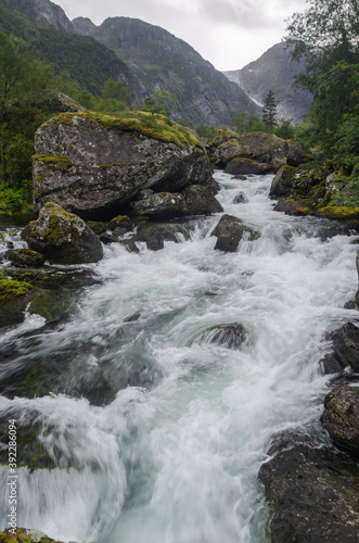 Wild creek in the rocky valley, Norway photo