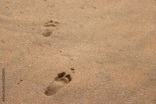 footprints in the sand. Human foot prints on seashore. Foot prints on beach