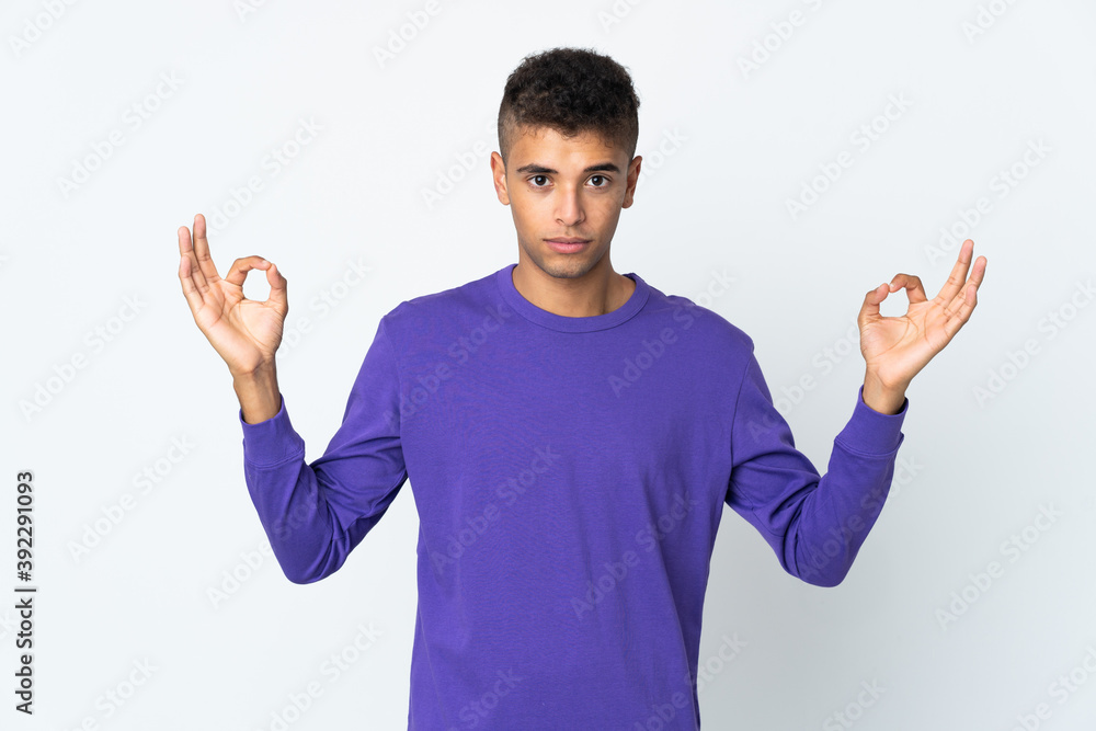 Young brazilian man isolated on white background in zen pose Young brazilian man isolated on white background in zen pose