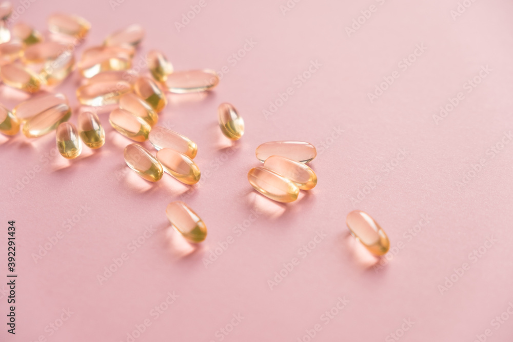 Pile of capsules Omega 3 on pink background. Close up, top view. Pile of capsules Omega 3 on pink background. Close up, top view.