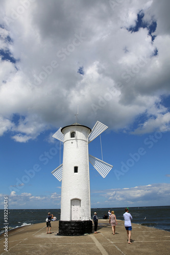 Wallpaper Mural A lighthouse by the sea in Poland, visited by tourists Torontodigital.ca