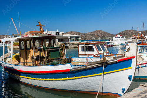 Colorful wooden fishing boat in a small harbour in Greece
