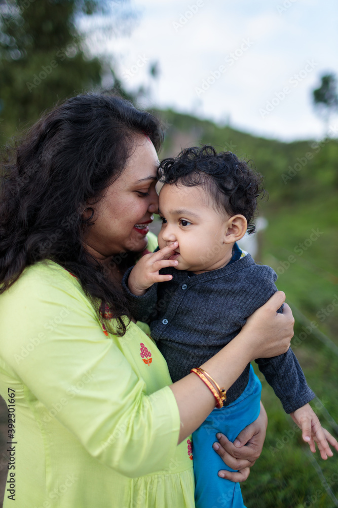 Mother sharing tender moment with her baby girl outdoors Mother sharing tender moment with her baby girl outdoors
