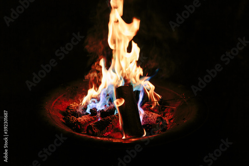 Firepit fire with coloured flames from specially coated pine con