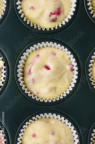 Macro shot of raspberry muffin batter in cake liner