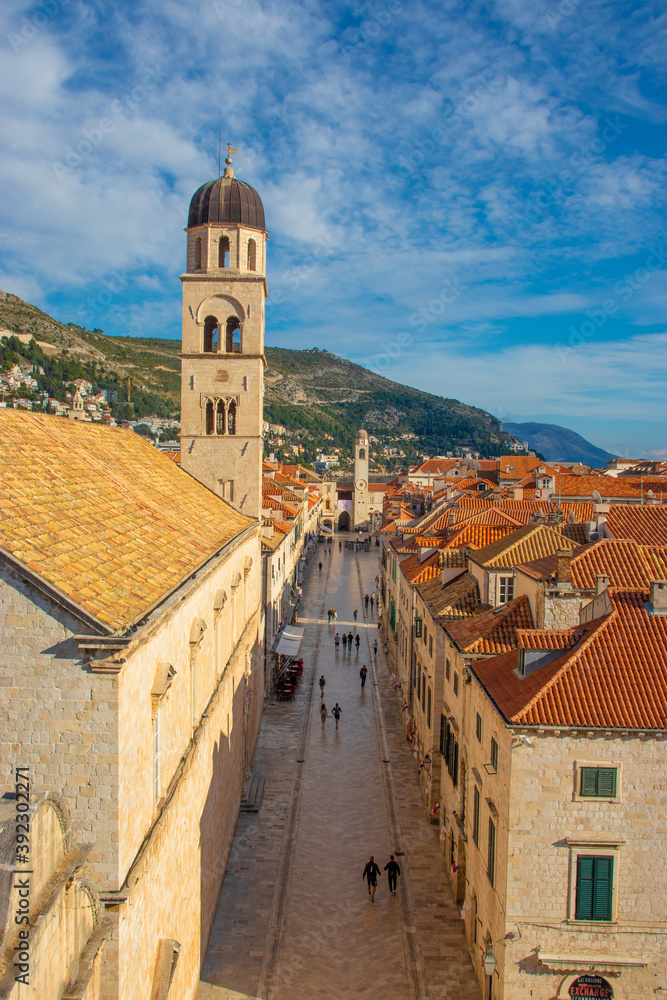 View of the famous Stradun street in the old town of Dubrovnik, as seen from above while climbing the city walls. Long narrow street surrounded by old houses