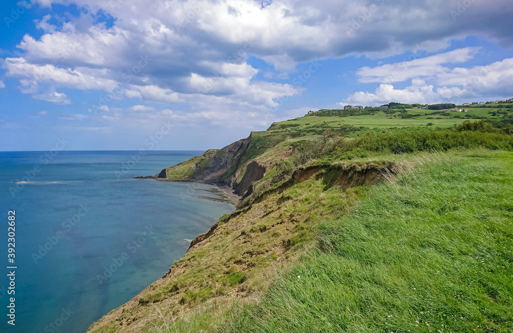 Looking along the cliff of Robin Hoods Bay in North Yorkshire towards Ravenscar