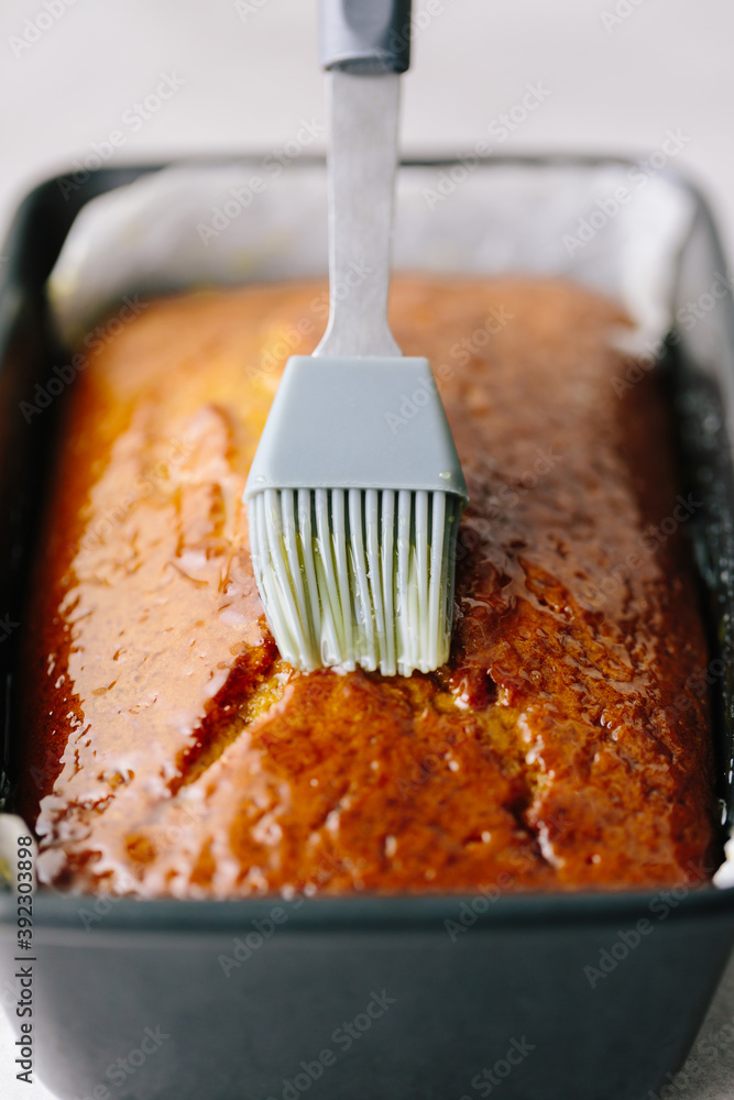 Brushing cake with syrup Stock Photo Adobe Stock