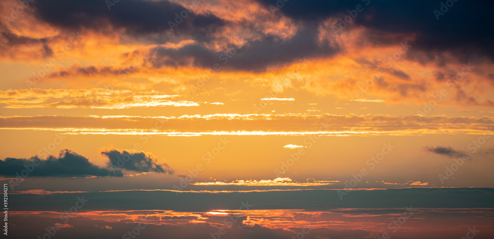 Sunrise clouds. Dramatic magical sunset over orange cloudy sky
