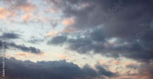 Dramatic magical sunrise cloudscape over blue gray color cloudy sky