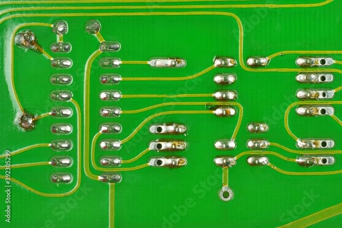 Close-Up a lead solder a pin of a IC 18 pin and  another electronic deviceon a pcb board. photo