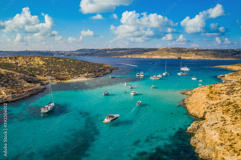 Aerial top drone view of Comino island, Blue lagoon and boats. Malta country