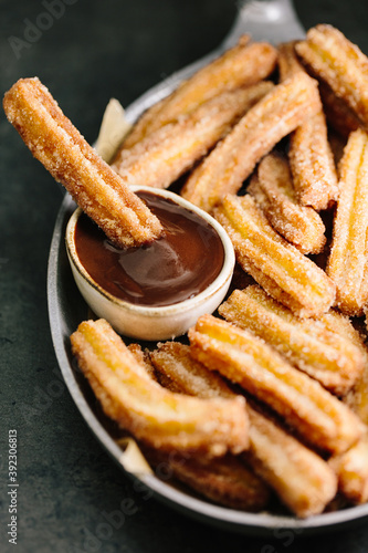 Close up of churros in chocolate sauce