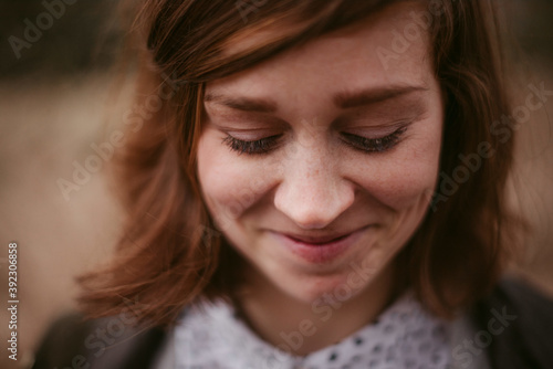 Happy timid young woman with lovely smile